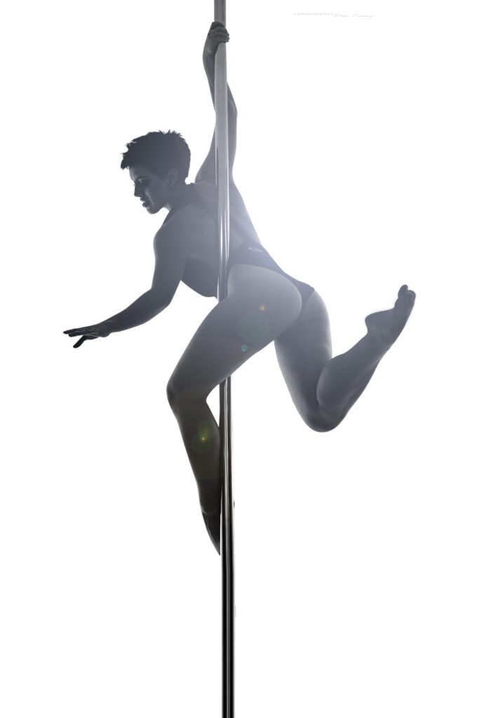 pole dance instructor Bambi posed on the pole