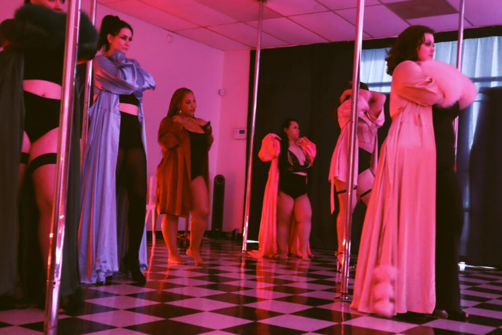 Students in action during a Galentine-themed burlesque class in Houston Texas led by Piper Daily. color photo.